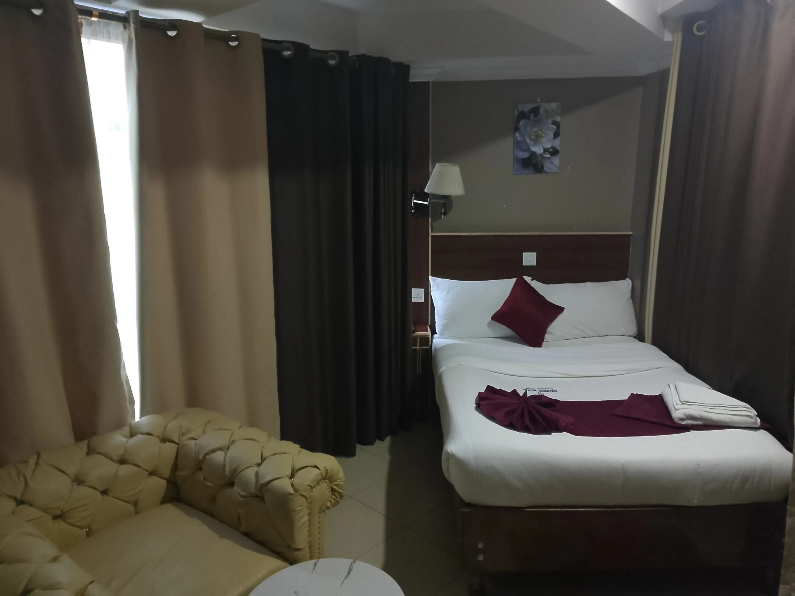 A single room at Generis Hotel with one bed, made up with white linen